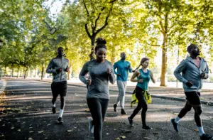 Friends participating in the BetterTogether weight loss challenge by jogging in a park