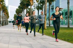 Participants in BetterTogether weight loss challenge group jogging in a city setting